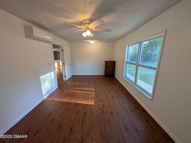 spare room with ceiling fan, baseboards, dark wood-style floors, and a wall mounted AC