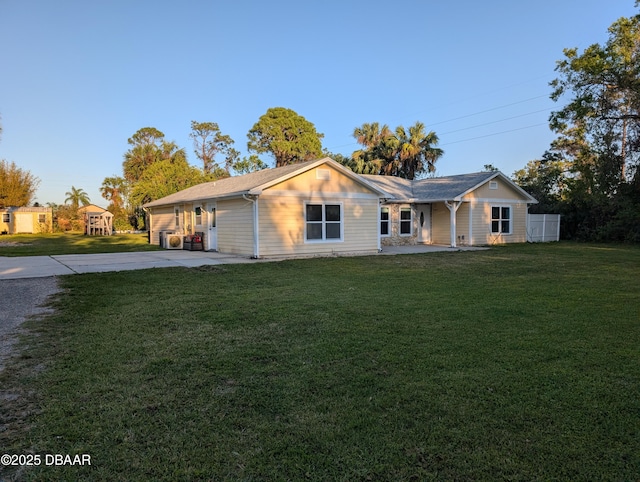 ranch-style home with driveway and a front lawn