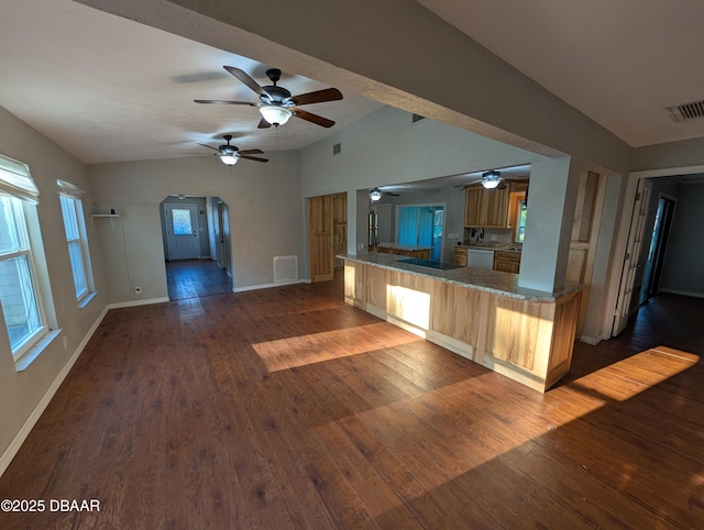 kitchen with visible vents, arched walkways, ceiling fan, and dark wood finished floors