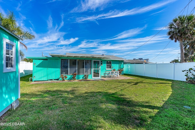 rear view of house with a yard and a patio