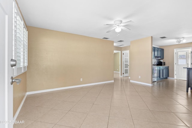 unfurnished living room with light tile patterned floors and ceiling fan