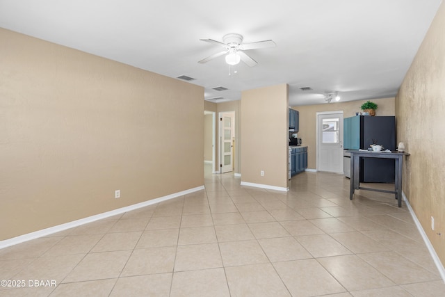 unfurnished living room with ceiling fan and light tile patterned floors