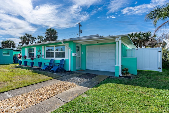 single story home featuring a garage and a front lawn