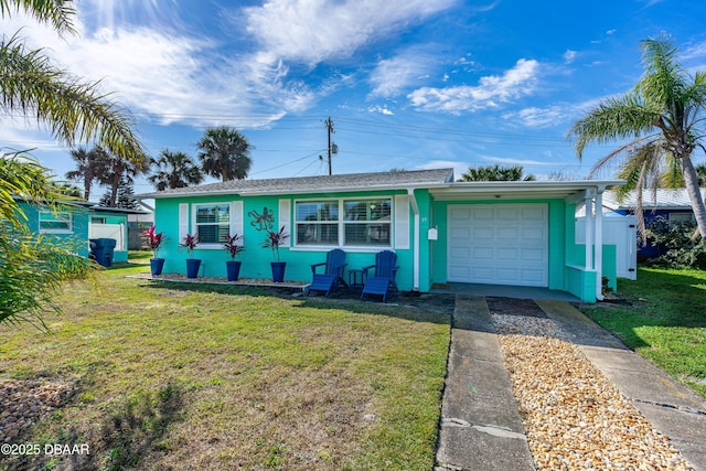 single story home featuring a garage and a front yard