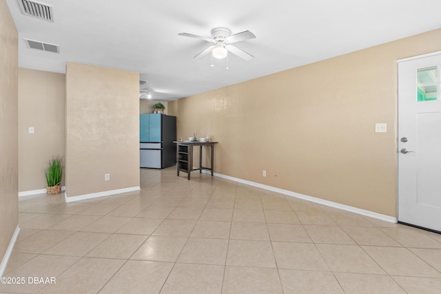 tiled empty room with ceiling fan