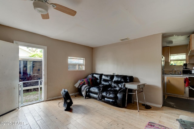 326 Jefferson St, Daytona Beach, FL 32114 - living room featuring light wood-style flooring, ceiling fan, and baseboards