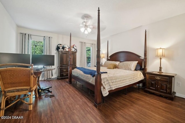 bedroom featuring multiple windows, ceiling fan, and dark hardwood / wood-style floors