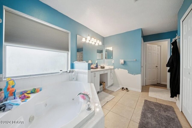 bathroom with vanity, tile patterned floors, and a relaxing tiled tub