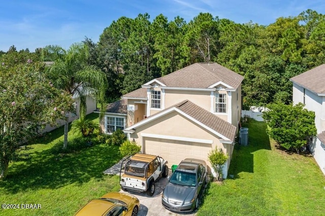 view of front facade featuring central air condition unit, a garage, and a front yard