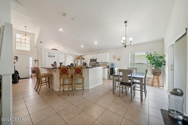 kitchen with white cabinetry, light tile patterned floors, pendant lighting, and appliances with stainless steel finishes