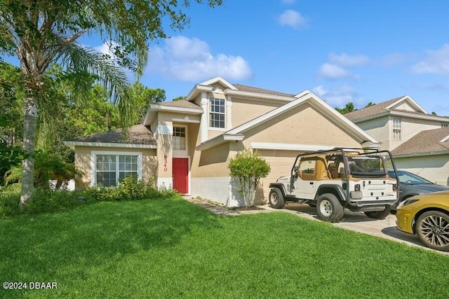 view of front facade with a garage and a front yard