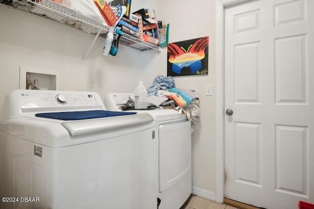 laundry area with light tile patterned floors and independent washer and dryer