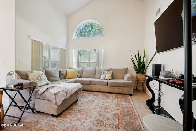 living room with high vaulted ceiling and light tile patterned floors