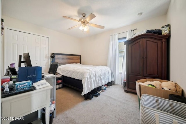 bedroom featuring ceiling fan, a closet, and light colored carpet