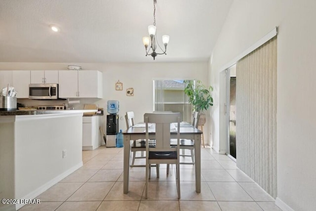 dining room featuring a notable chandelier and light tile patterned flooring