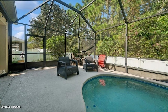 view of pool with a patio area and a lanai