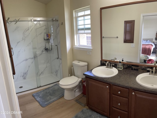 bathroom featuring vanity, hardwood / wood-style flooring, toilet, and walk in shower