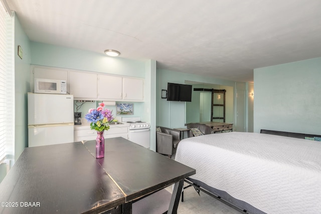 bedroom with freestanding refrigerator
