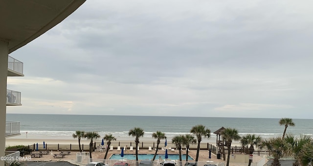 view of water feature with a view of the beach and fence