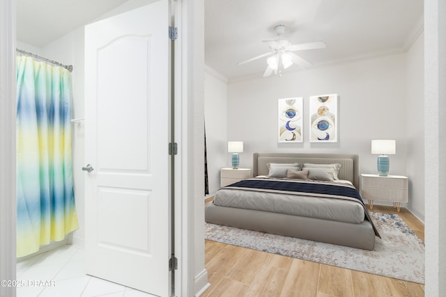 bedroom featuring a ceiling fan, wood finished floors, and crown molding