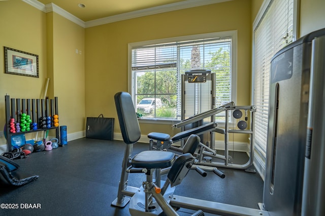 workout area with baseboards and ornamental molding