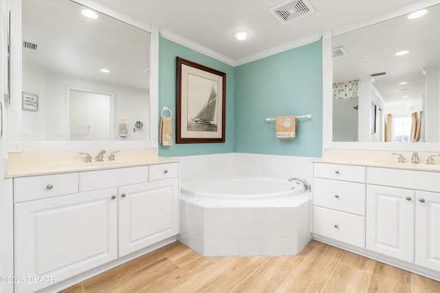 full bath with a garden tub, wood finished floors, visible vents, and a sink