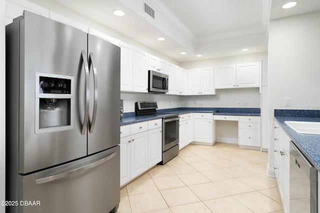 kitchen featuring white cabinetry, visible vents, appliances with stainless steel finishes, and ornamental molding