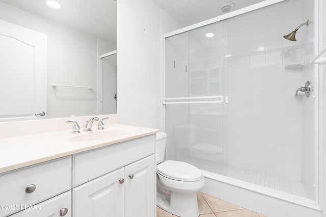 full bath with vanity, recessed lighting, a stall shower, tile patterned flooring, and toilet