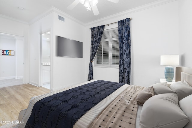 bedroom featuring wood finished floors, baseboards, visible vents, ornamental molding, and connected bathroom