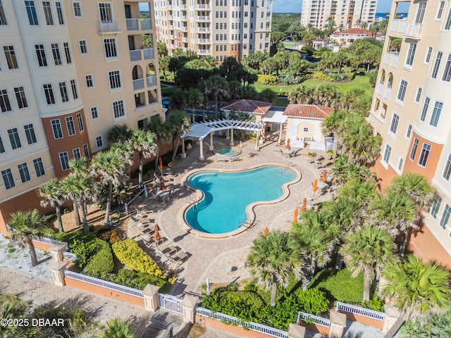 view of pool featuring a patio, a city view, a pergola, and fence