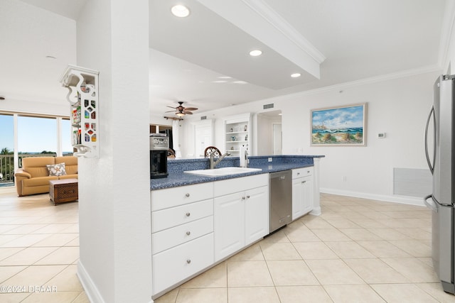 kitchen with white cabinets, sink, light tile patterned floors, ornamental molding, and appliances with stainless steel finishes