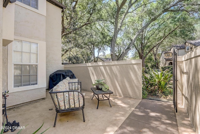 view of patio / terrace featuring a grill and fence