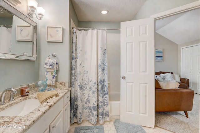 full bathroom featuring vanity, lofted ceiling, shower / tub combo with curtain, and a textured ceiling