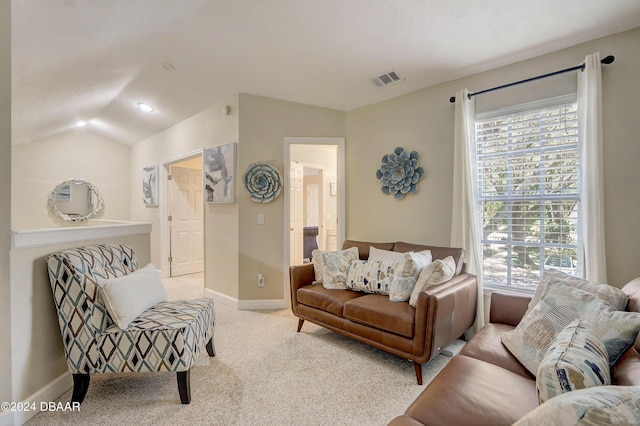 living room with lofted ceiling, carpet flooring, visible vents, and baseboards