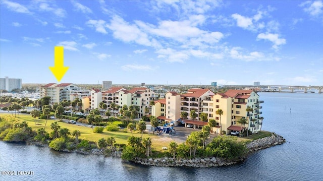 drone / aerial view featuring a view of city and a water view