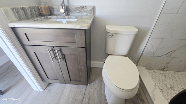 219 S Atlantic Ave Unit 120, Daytona Beach, FL 32118 - bathroom with toilet, a shower stall, vanity, and wood finished floors