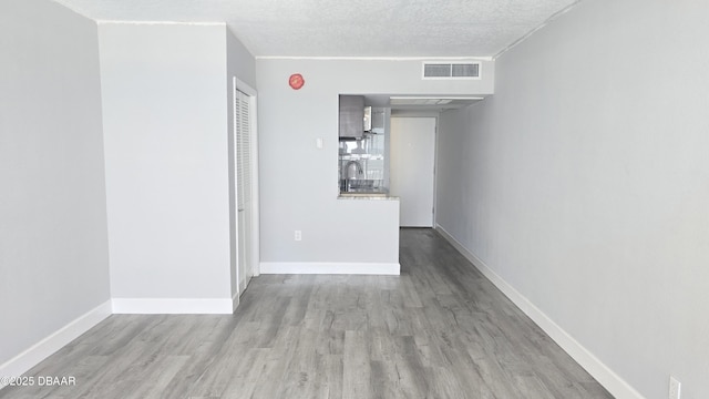 219 S Atlantic Ave Unit 120, Daytona Beach, FL 32118 - empty room featuring a sink, visible vents, baseboards, and wood finished floors