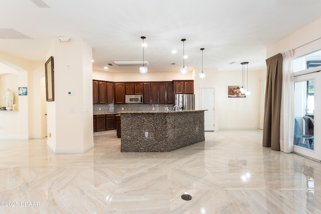 26 Ethel Ln, Palm Coast, FL 32164 - kitchen featuring baseboards, dark brown cabinets, stainless steel refrigerator with ice dispenser, arched walkways, and tasteful backsplash