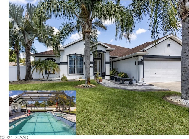 view of front of house with a front yard, glass enclosure, and a garage