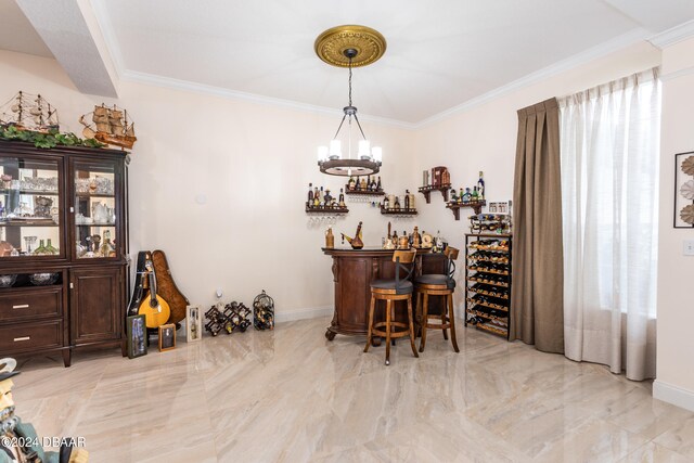 wine area with bar area, crown molding, and a notable chandelier