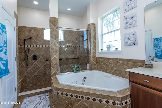 bathroom with vanity and separate shower and tub