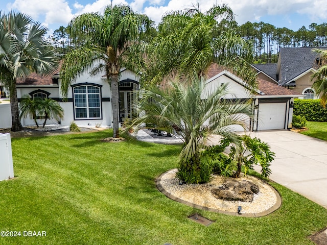 view of front facade featuring a garage and a front lawn