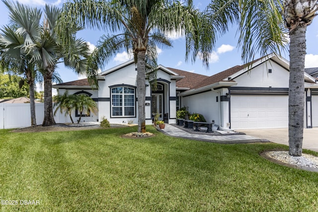 26 Ethel Ln, Palm Coast, FL 32164 - view of front of property featuring an attached garage, stucco siding, fence, concrete driveway, and a front yard