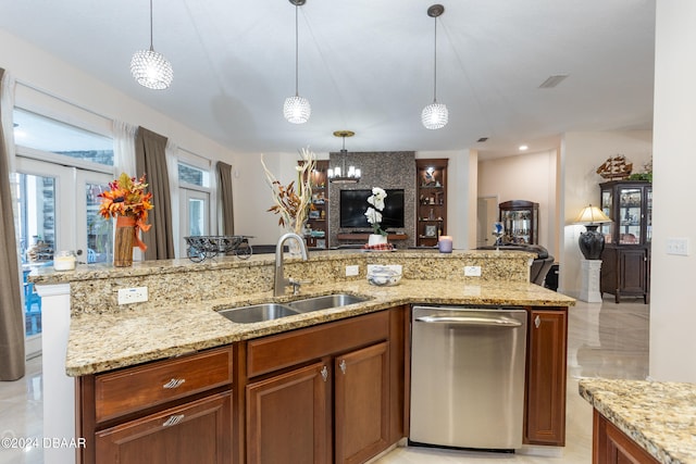 kitchen featuring light stone countertops, french doors, sink, pendant lighting, and dishwasher