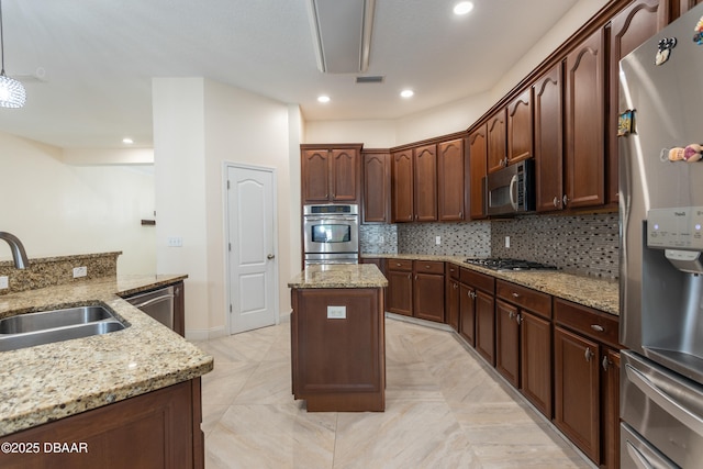 26 Ethel Ln, Palm Coast, FL 32164 - kitchen featuring light stone counters, a sink, decorative backsplash, a kitchen island, and stainless steel appliances