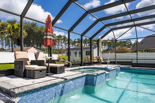 26 Ethel Ln, Palm Coast, FL 32164 - view of swimming pool featuring a pool with connected hot tub, a patio area, glass enclosure, an outbuilding, and a fenced backyard
