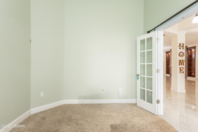 26 Ethel Ln, Palm Coast, FL 32164 - empty room featuring baseboards and decorative columns