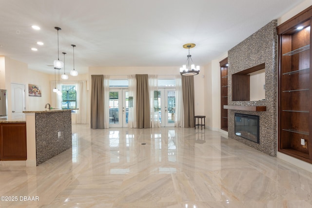 26 Ethel Ln, Palm Coast, FL 32164 - unfurnished living room featuring marble finish floor, a fireplace, french doors, and recessed lighting