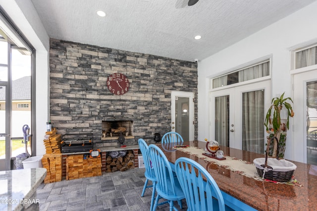 26 Ethel Ln, Palm Coast, FL 32164 - dining area featuring a stone fireplace, a wealth of natural light, french doors, and recessed lighting