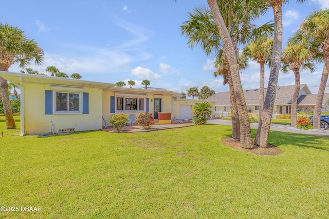 327 Due E St, New Smyrna Beach, FL 32169 - ranch-style home featuring a garage and a front lawn